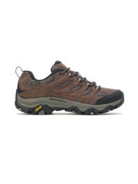 Men's Brown and Gray Merrell Hiking Shoes Holding Stick · Free Stock Photo