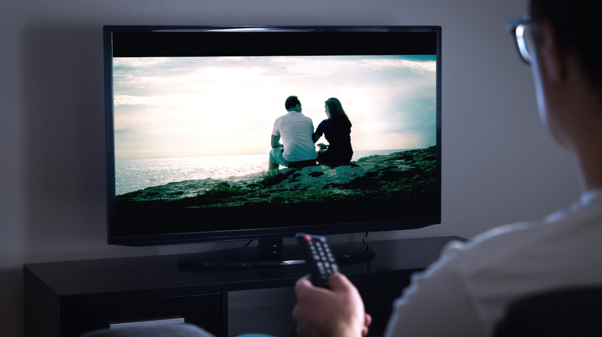 man-pointing-remote-oled-tv